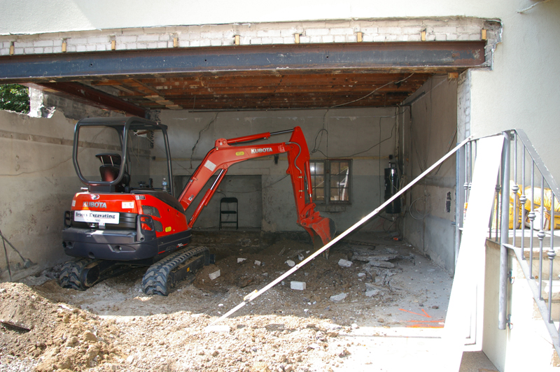 Kubota mini-excavator working in a tight-access residential yard, Bruce's Excavating